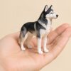 Essential — the figurine resting in a hand, showing its size Essential — the figurine resting in a hand, showing its size