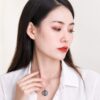 Silver Memorial Pendant — held to the light Silver Memorial Pendant — held to the light